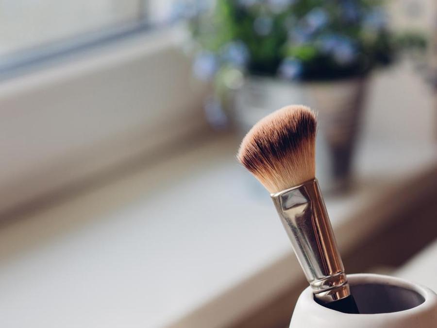 a makeup brush with a brush and a flower - Makeup Brush